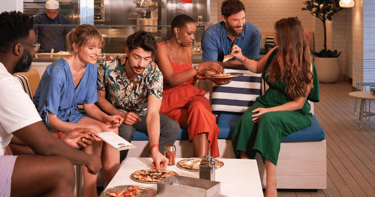 A group enjoys fresh, made-to-order pizza at The Pizza Place